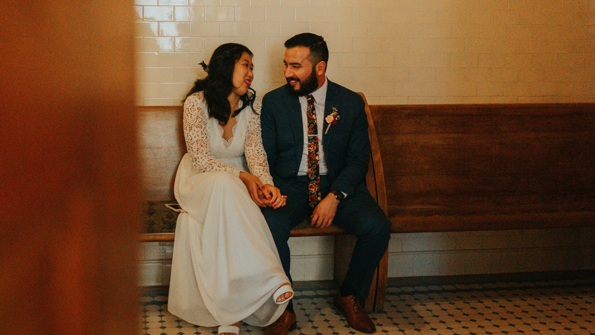 man and woman standing on brown wooden hallway