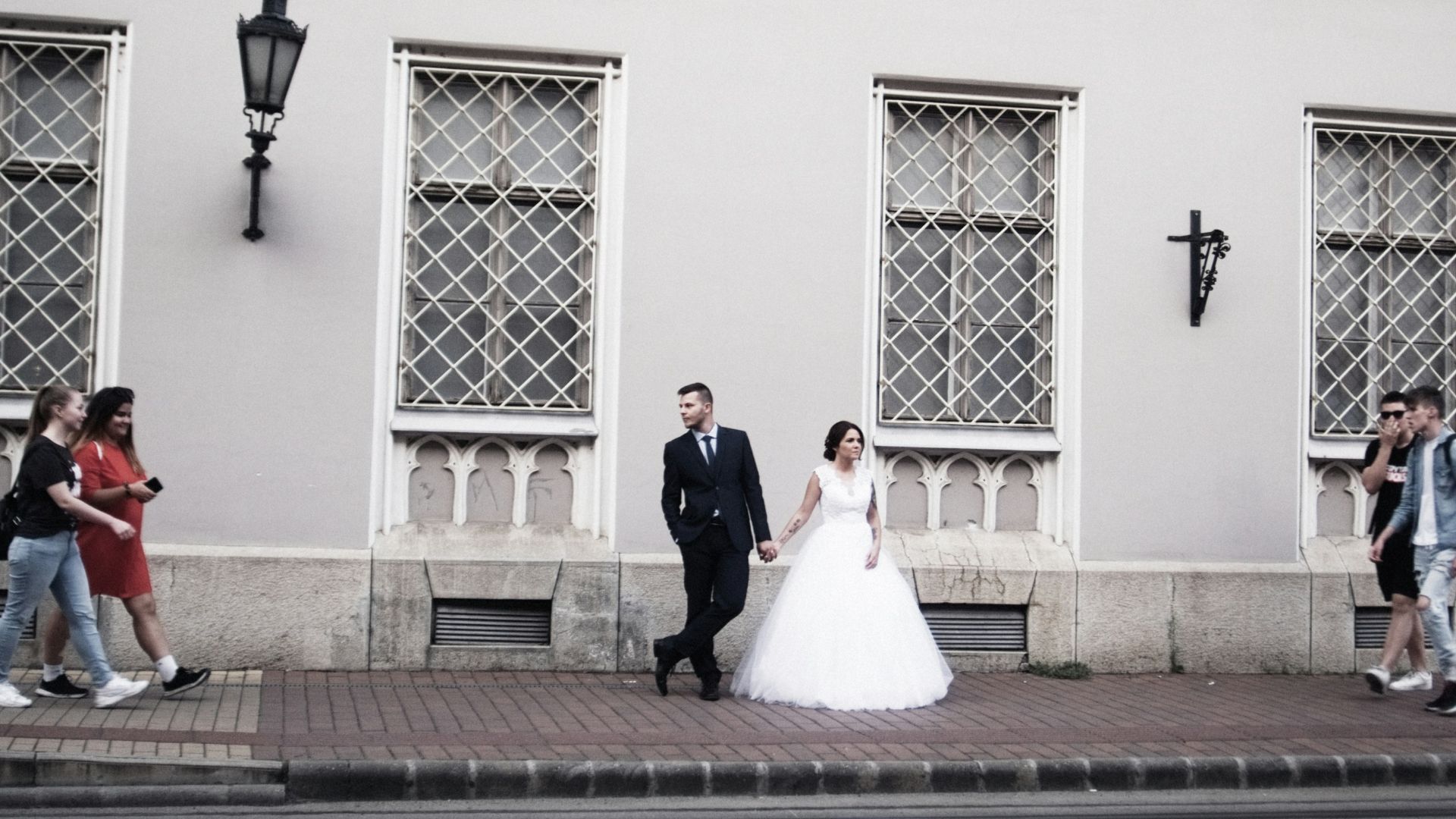 man and woman walking on sidewalk during daytime