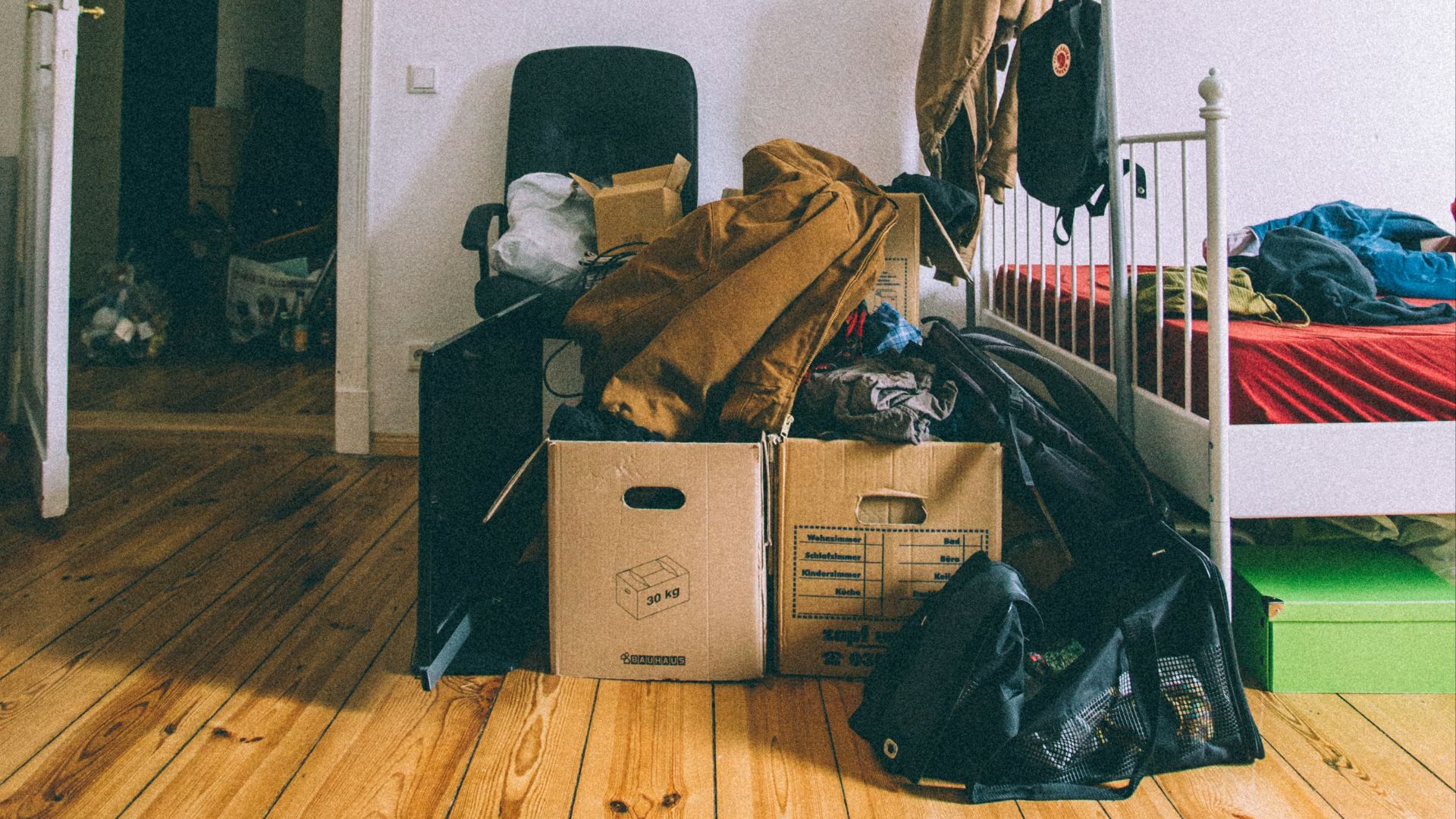 brown cardboard boxes on brown wooden parquet floor