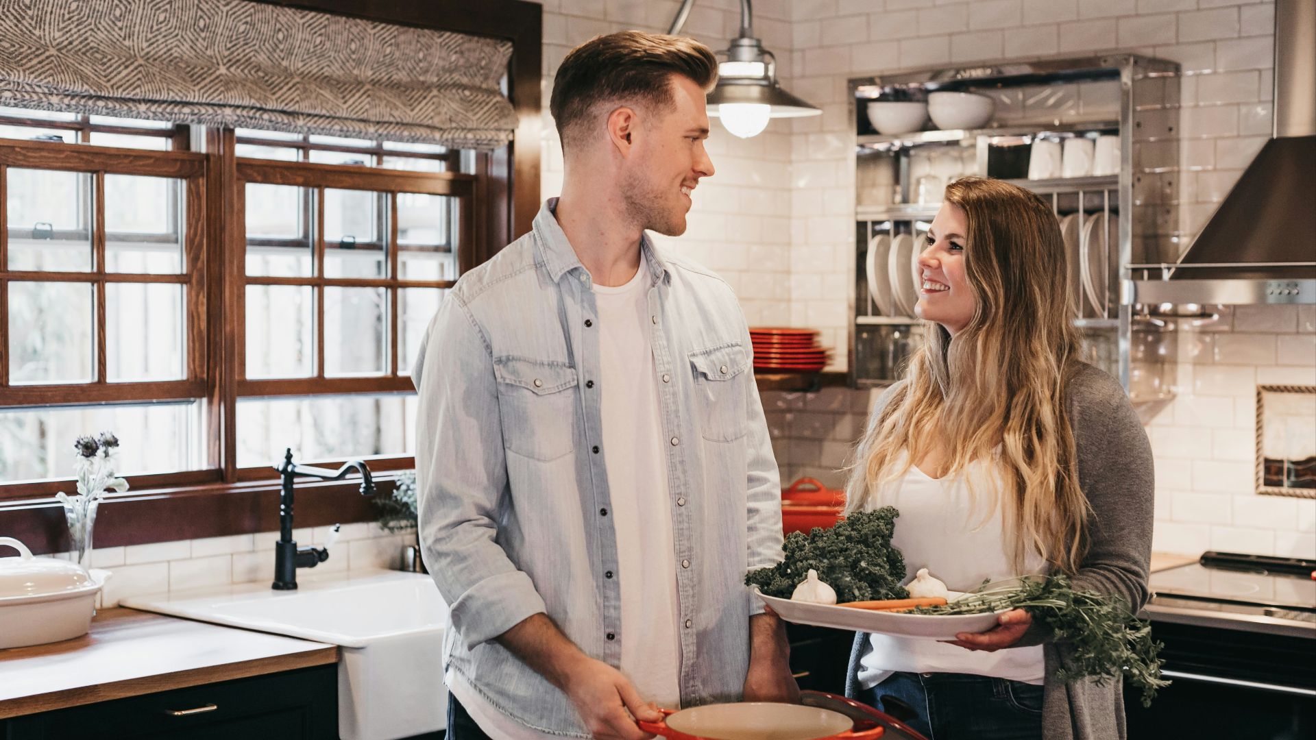 man and woman standing inside kitchen room