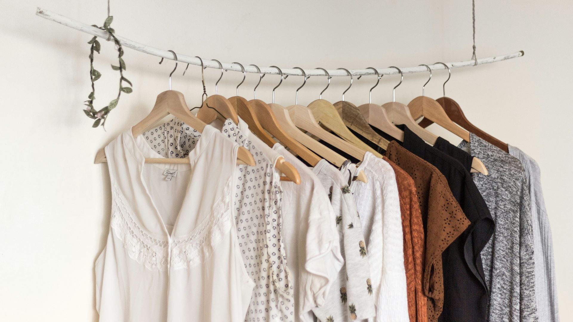 assorted clothes in wooden hangers