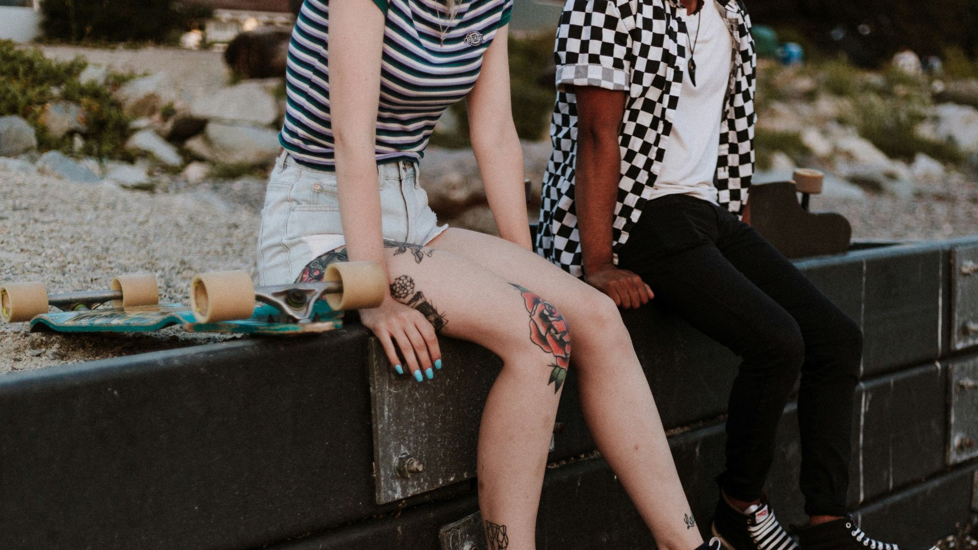 two person sits on fence