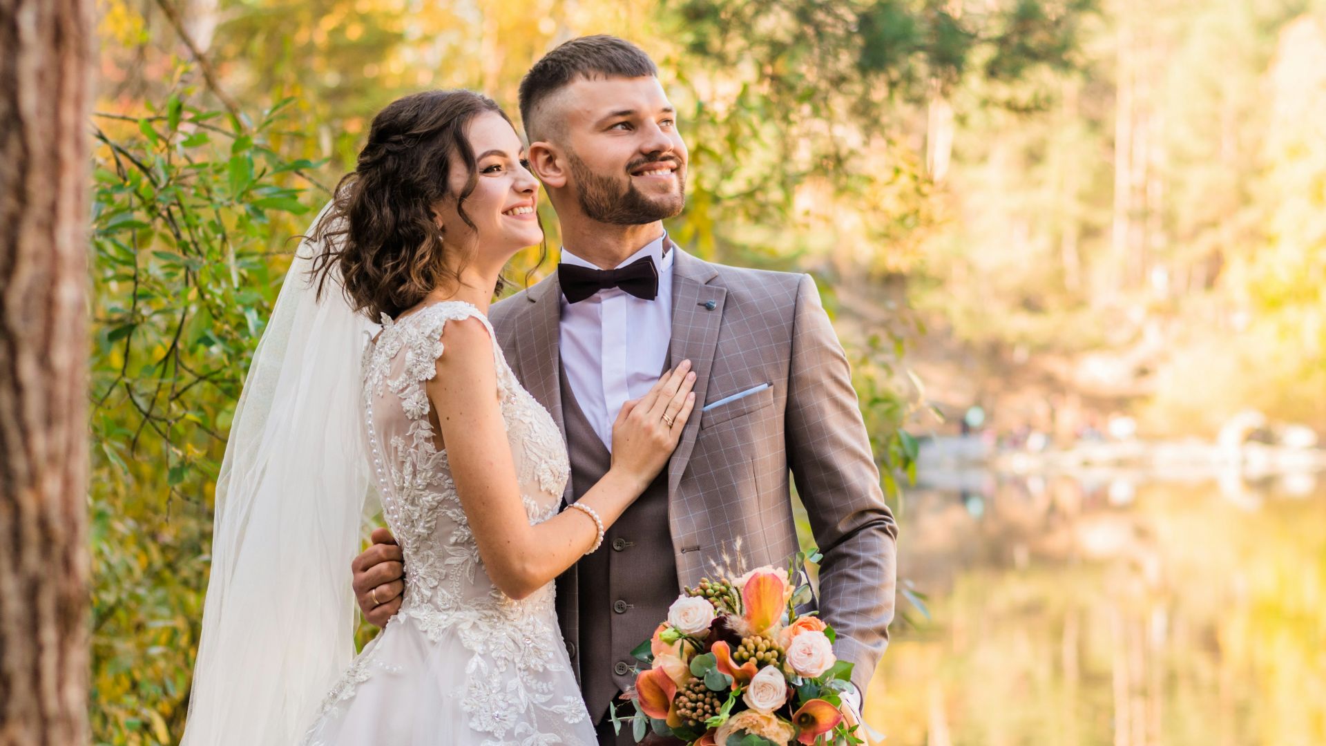 man in gray suit and woman in white wedding dress