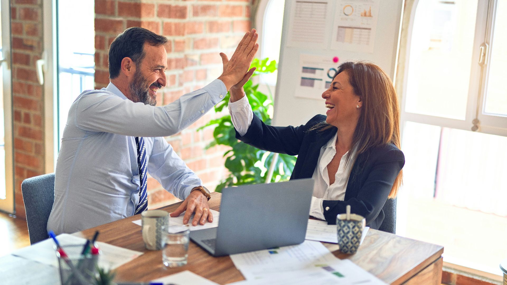 man in white dress shirt sitting beside woman in black long sleeve shirt