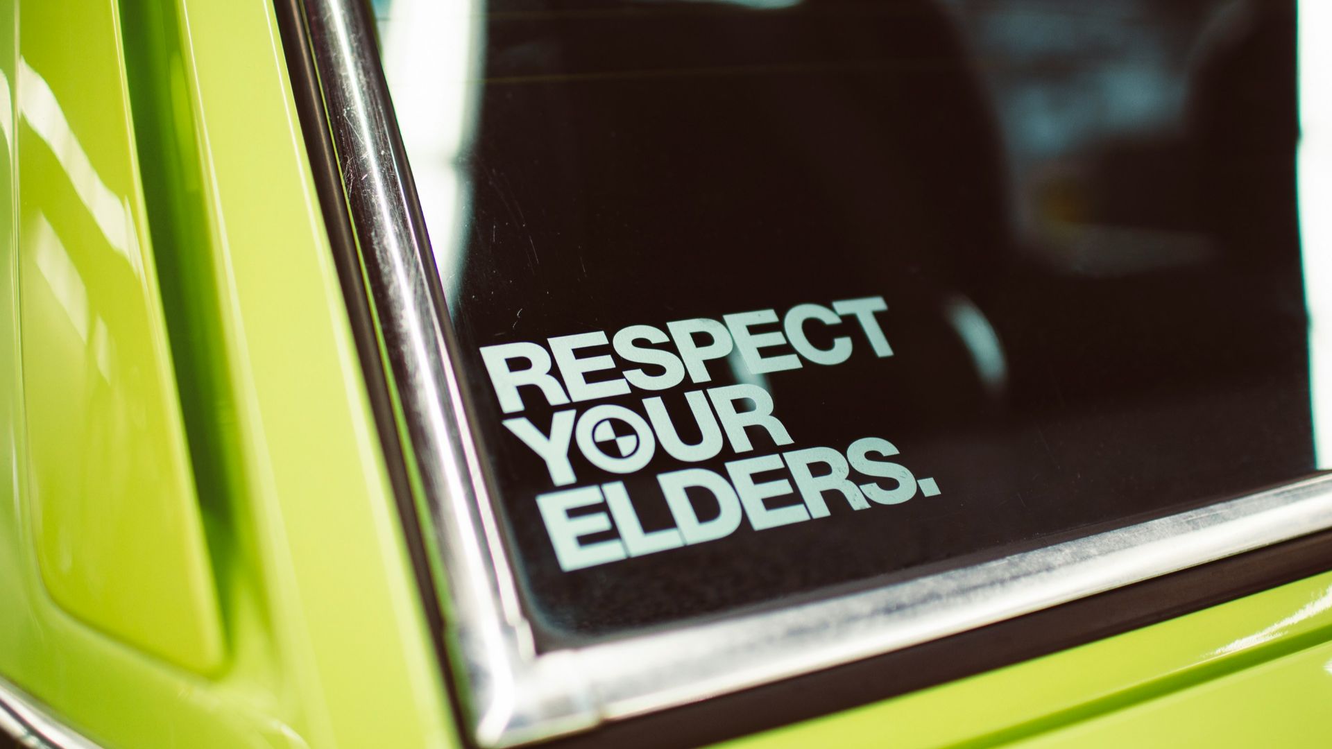 respect your elders sign on car window