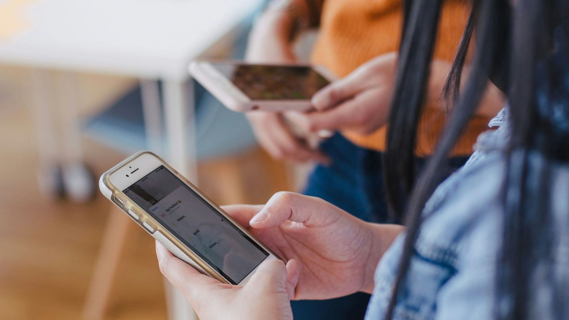 selective focus photography of woman holding phone