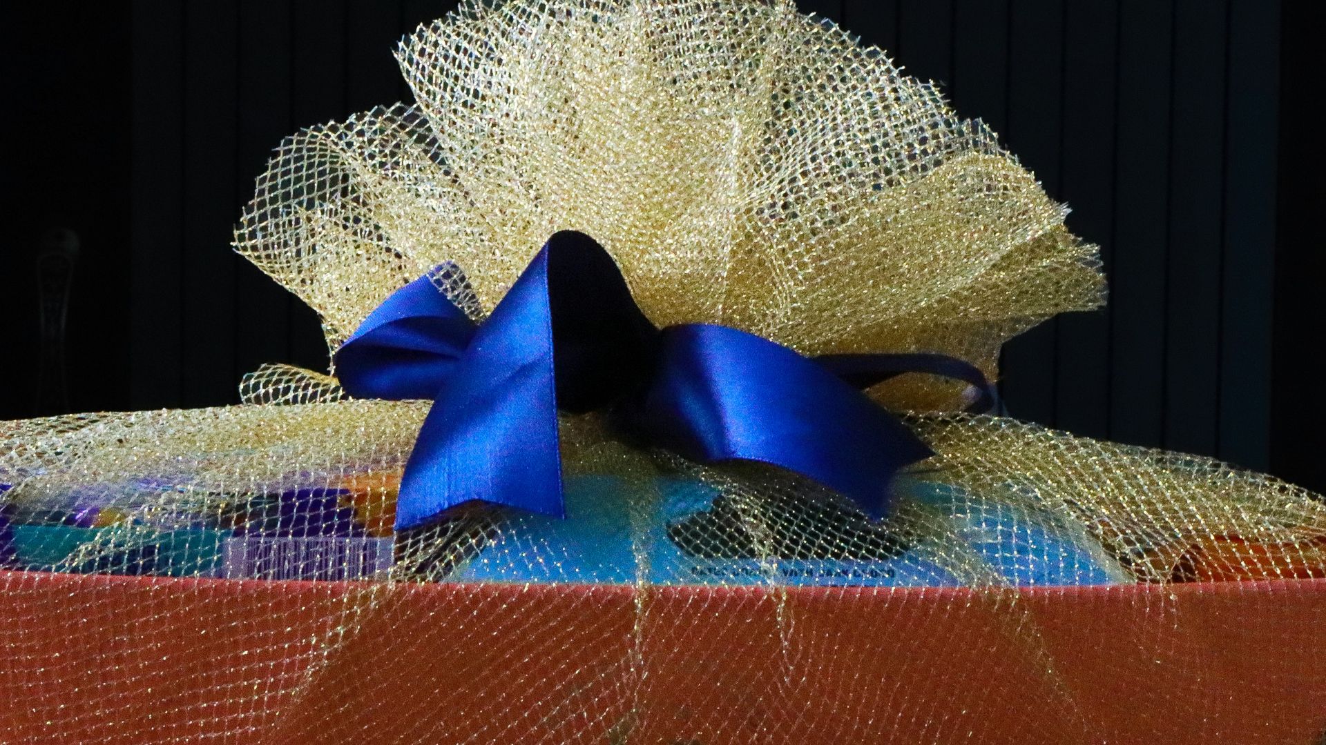 A basket with a blue bow on top of it