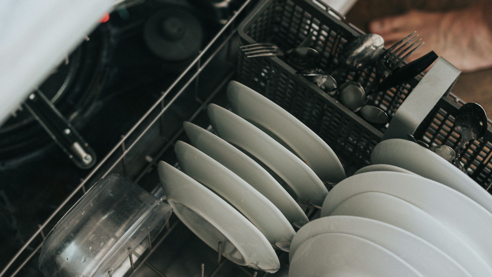 white ceramic plate on black dishwasher