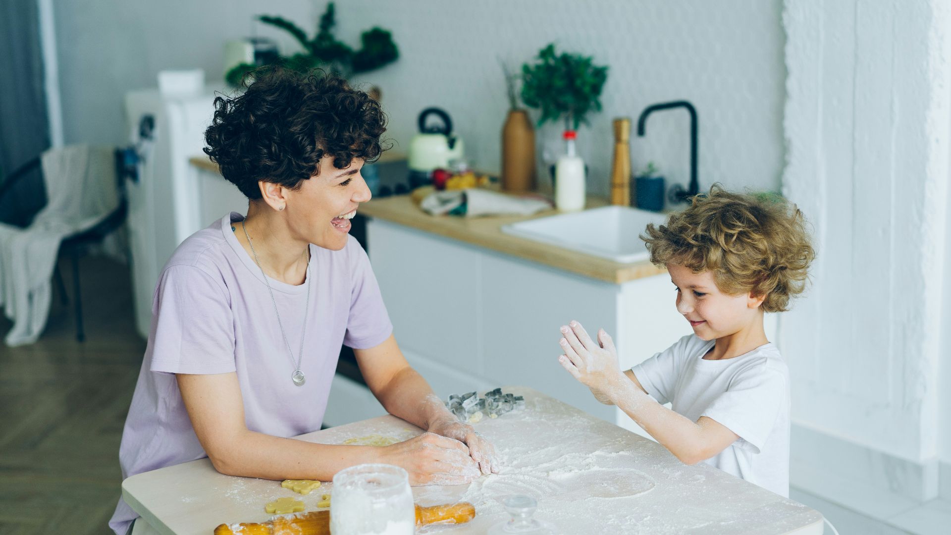 a woman and a child sitting at a kitchen table