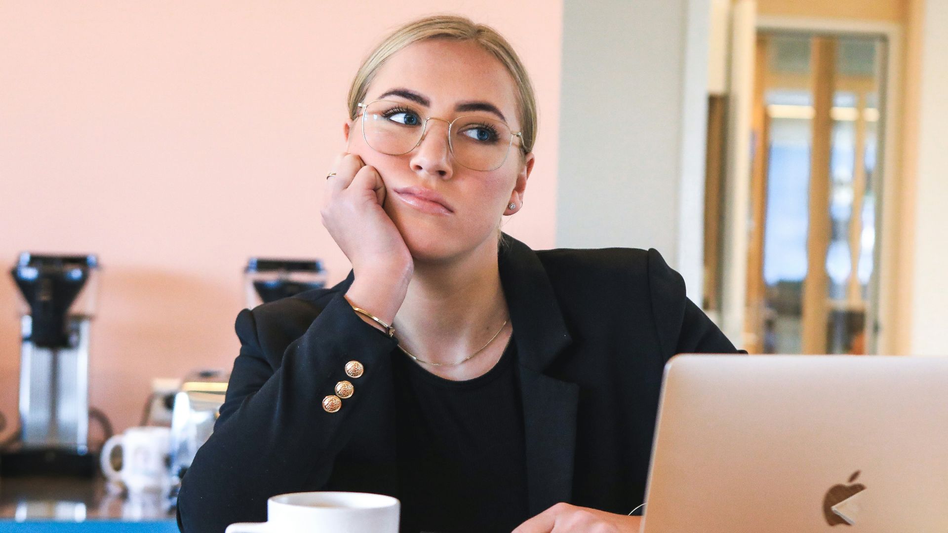 woman in black long sleeve shirt using macbook