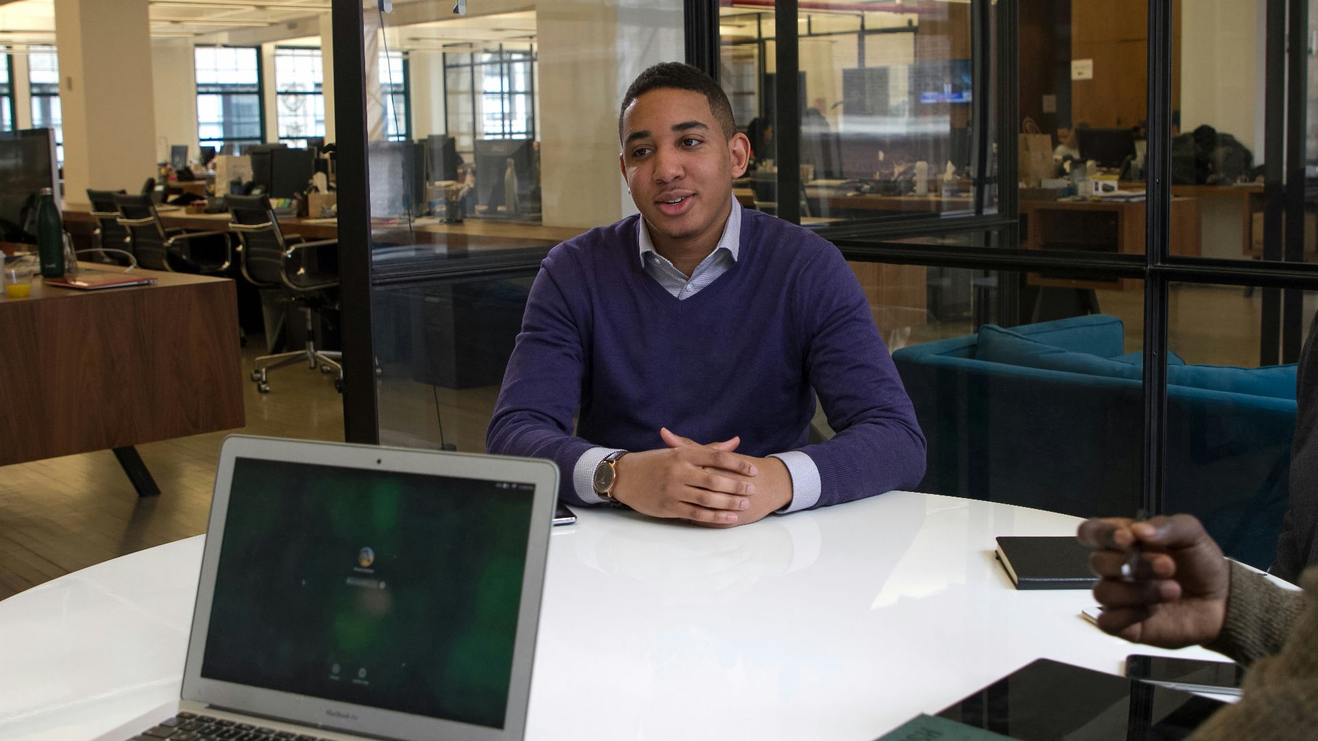 a man sitting at a table with a laptop