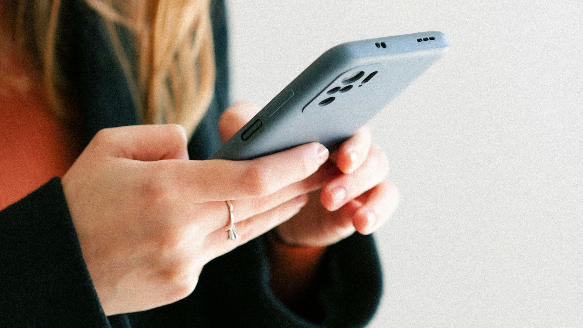 a woman holding a cell phone in her hands
