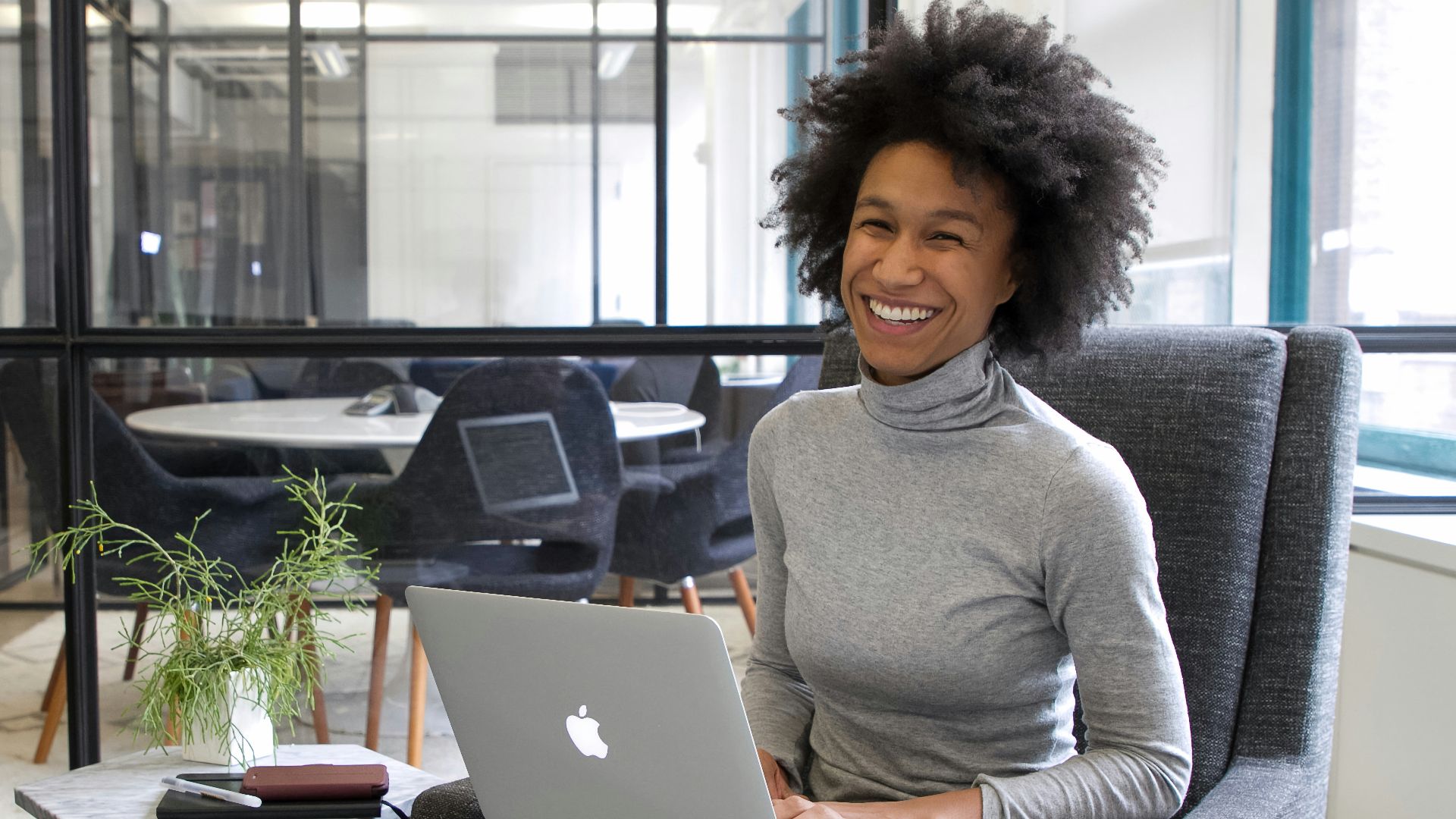 a woman sitting in a chair with a laptop