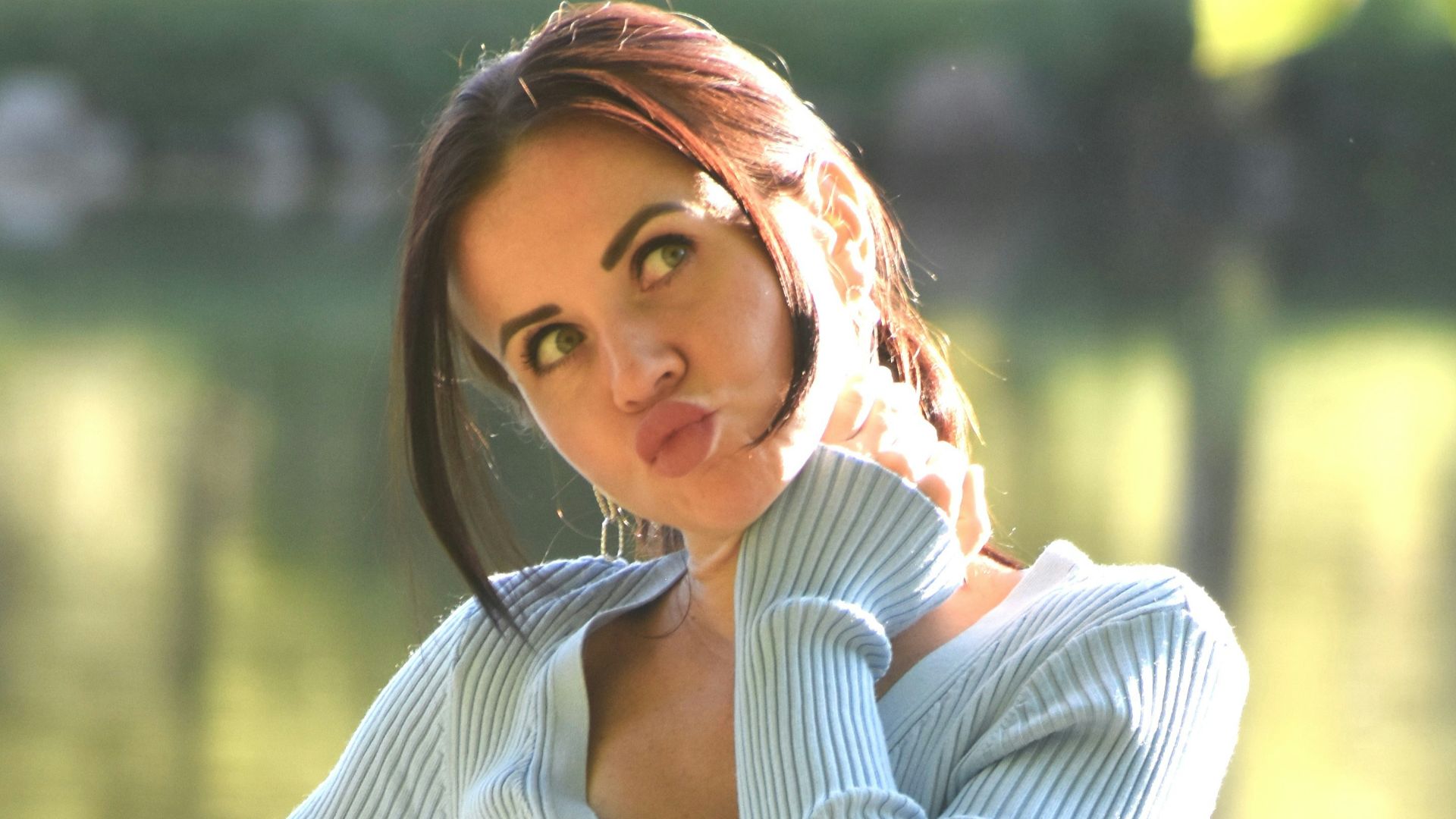 A woman standing on a rock near a body of water