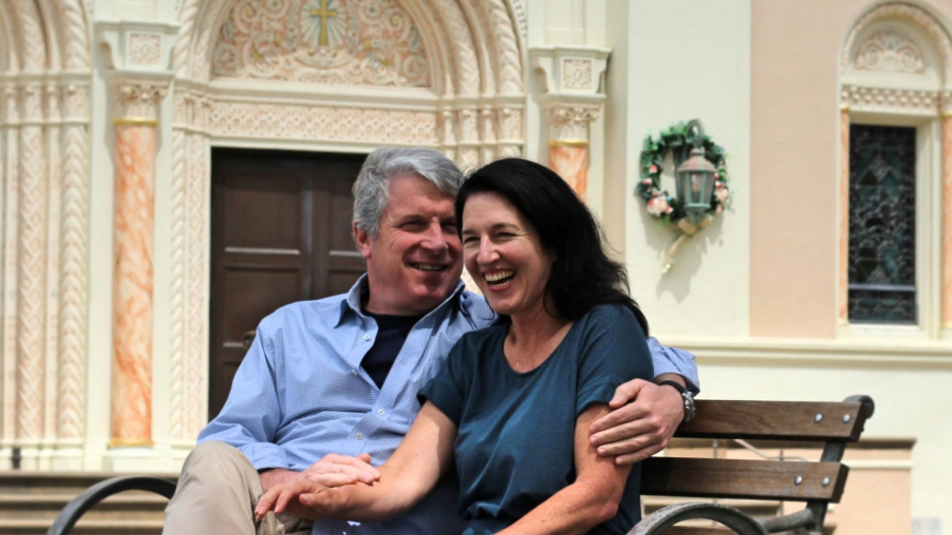man and woman sitting on bench