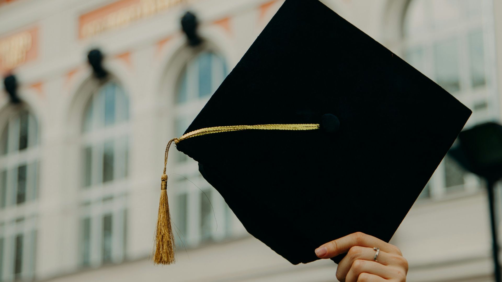 person holding black academic hat