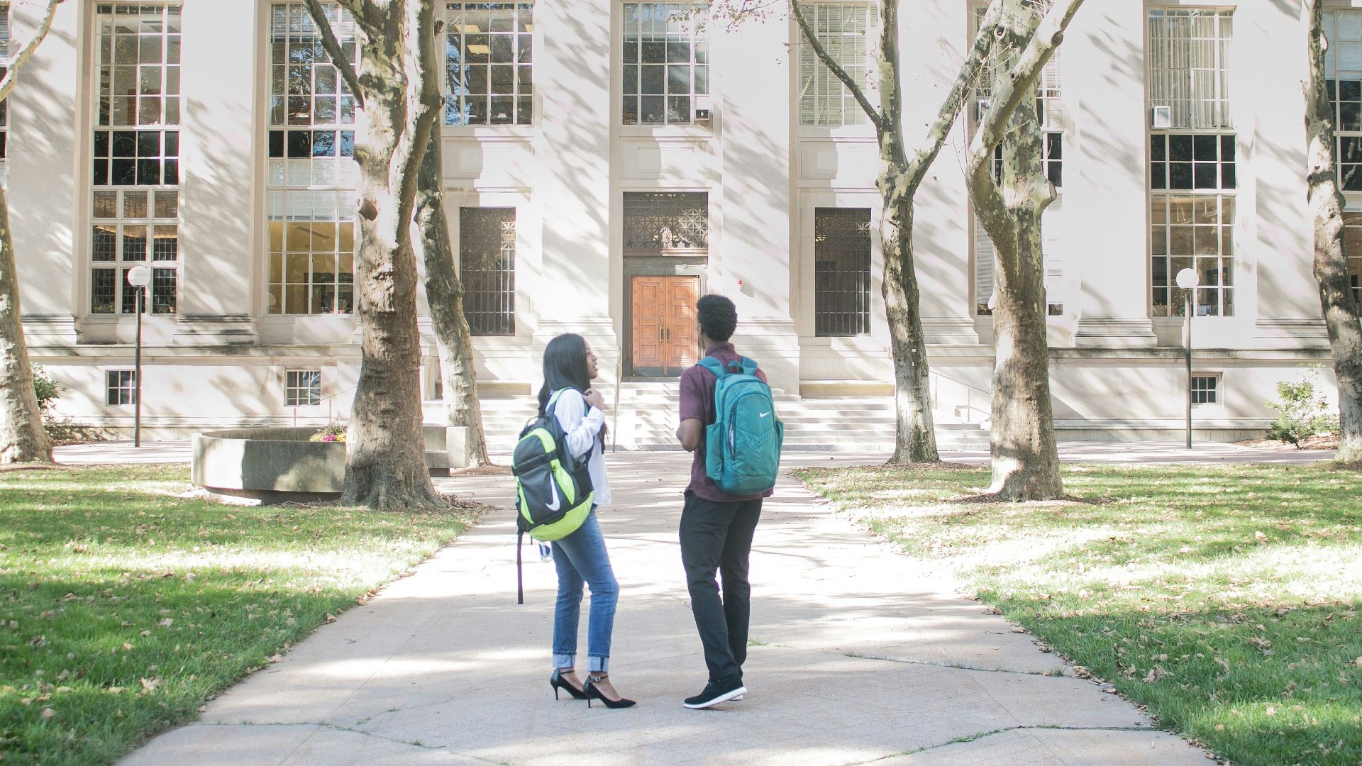 a couple of people that are standing in front of a building