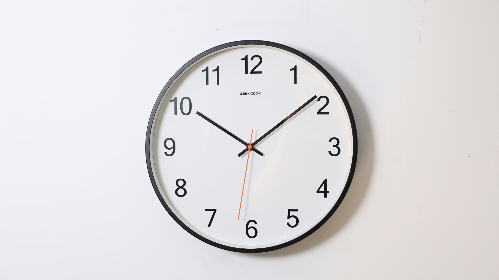 round analog wall clock pointing at 10:09