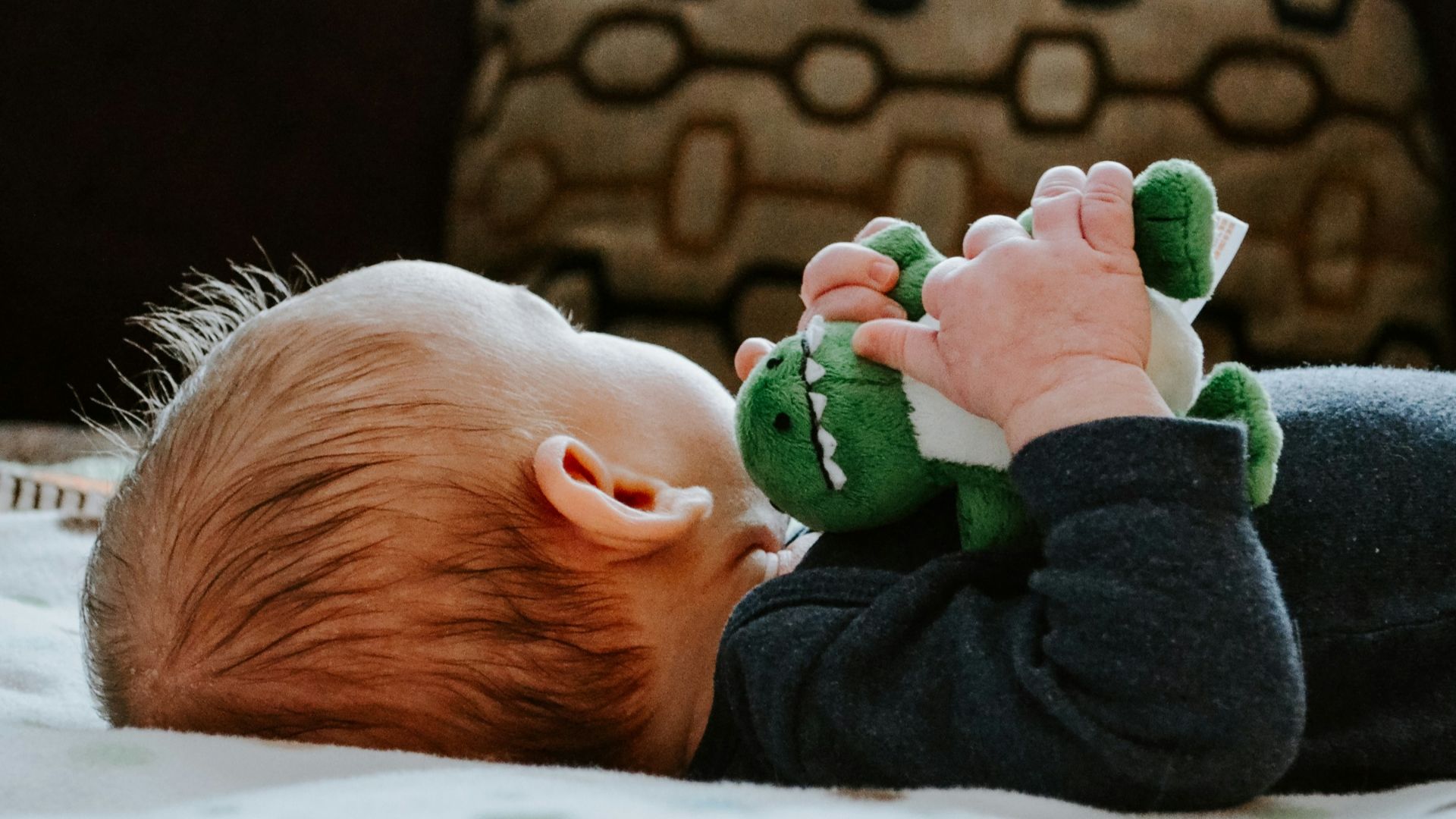 baby lying on white bed