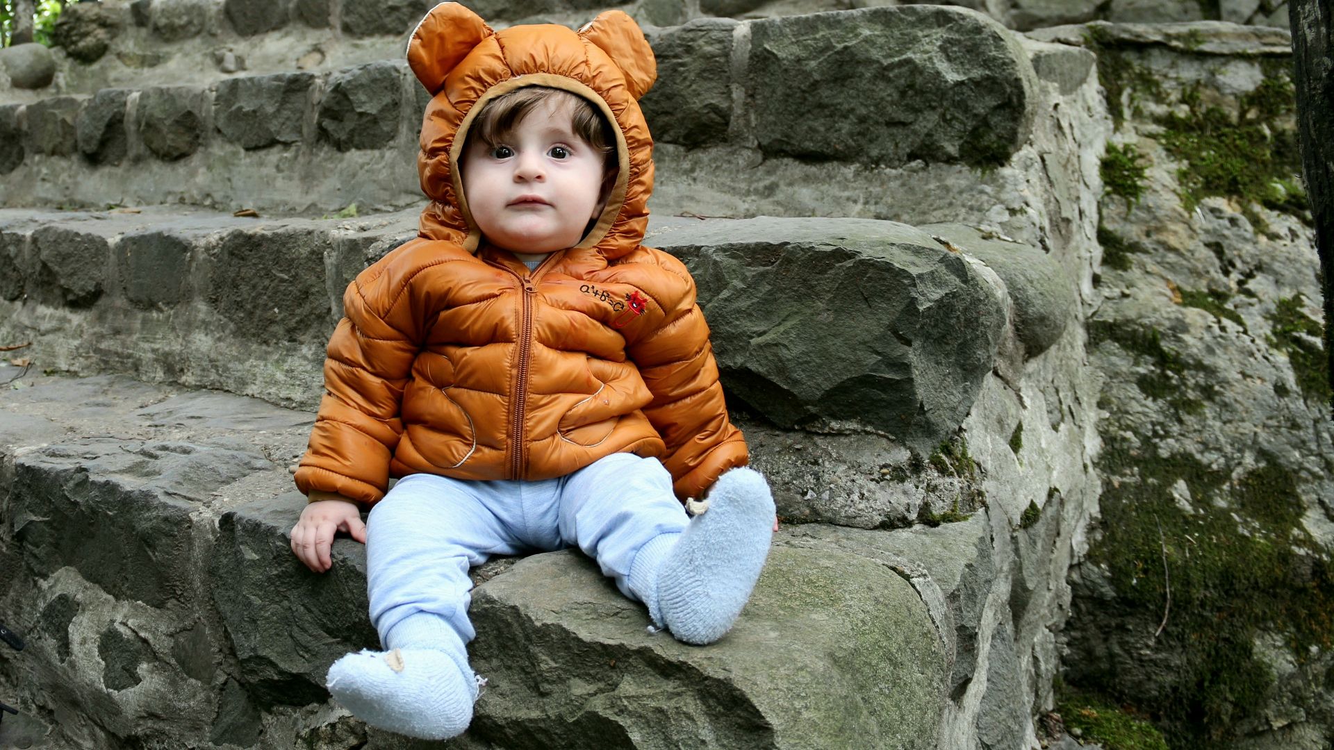 a small child sitting on some steps