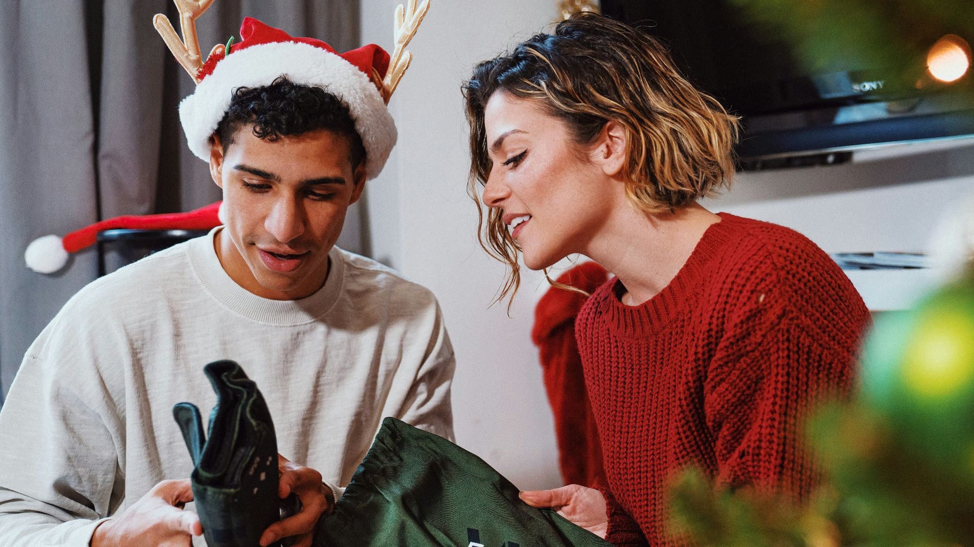 a man and woman looking at a cell phone