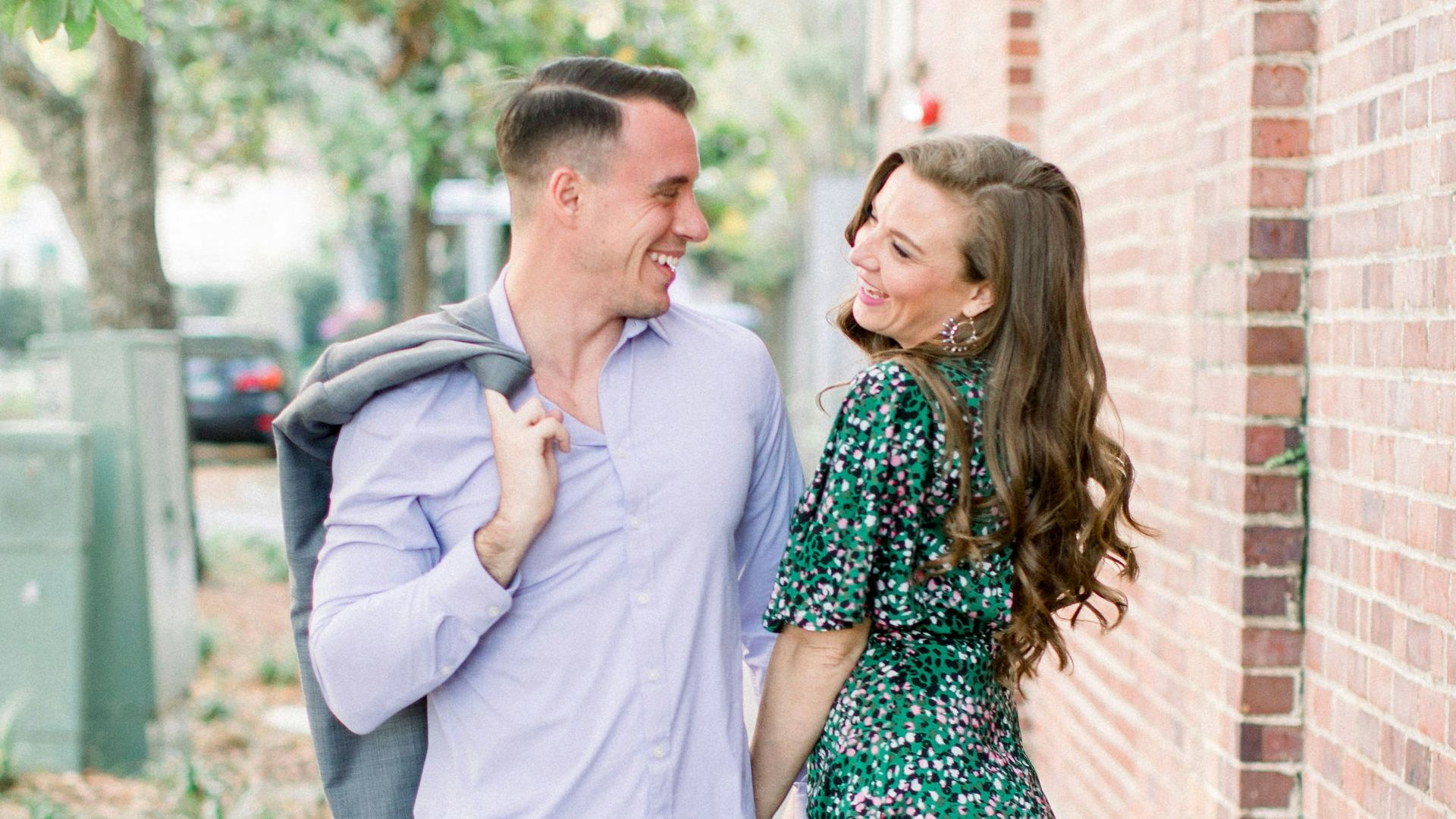 woman in white long sleeve shirt standing beside woman in green and white floral dress