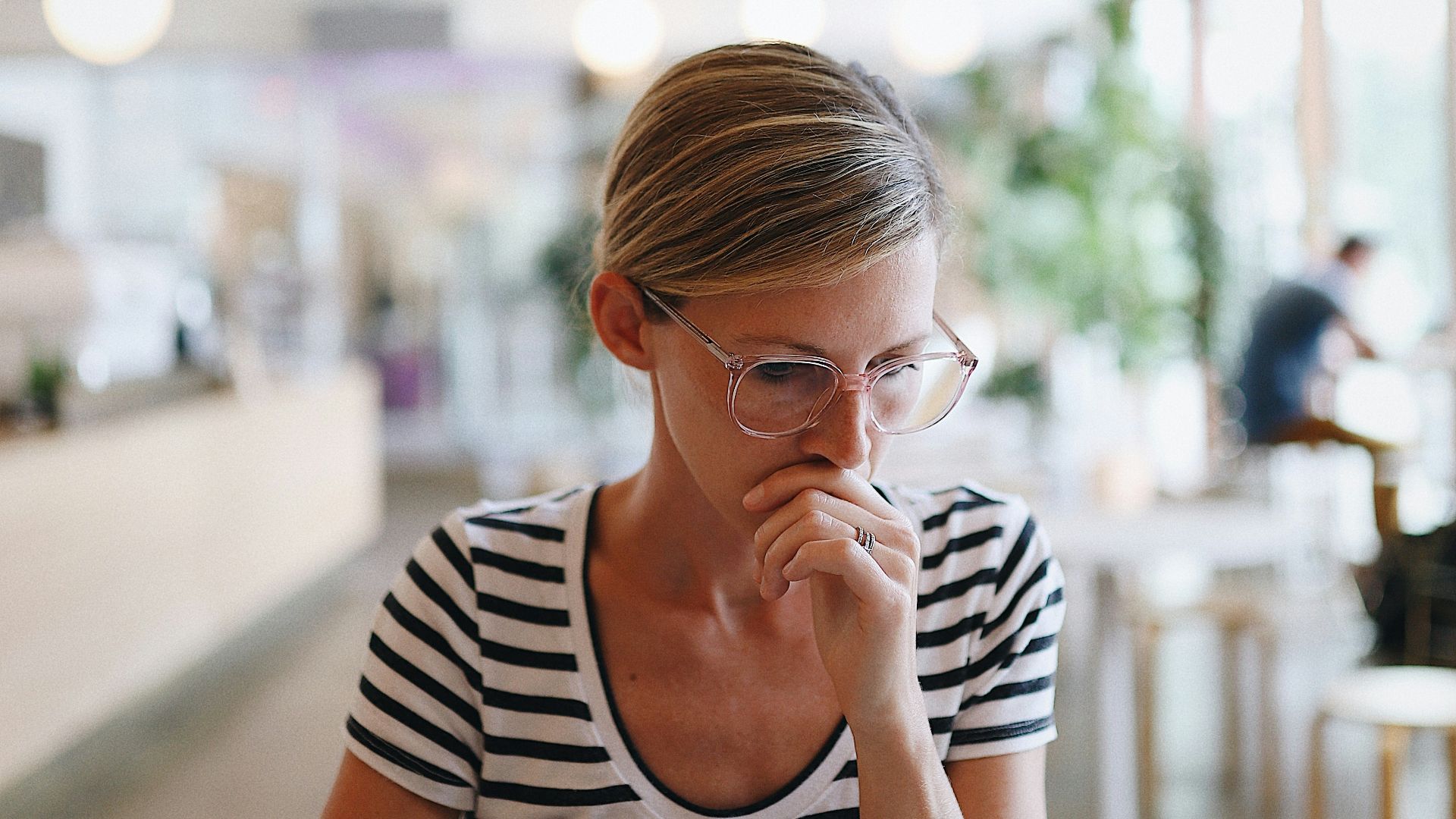 woman in black and white striped shirt sitting on chair