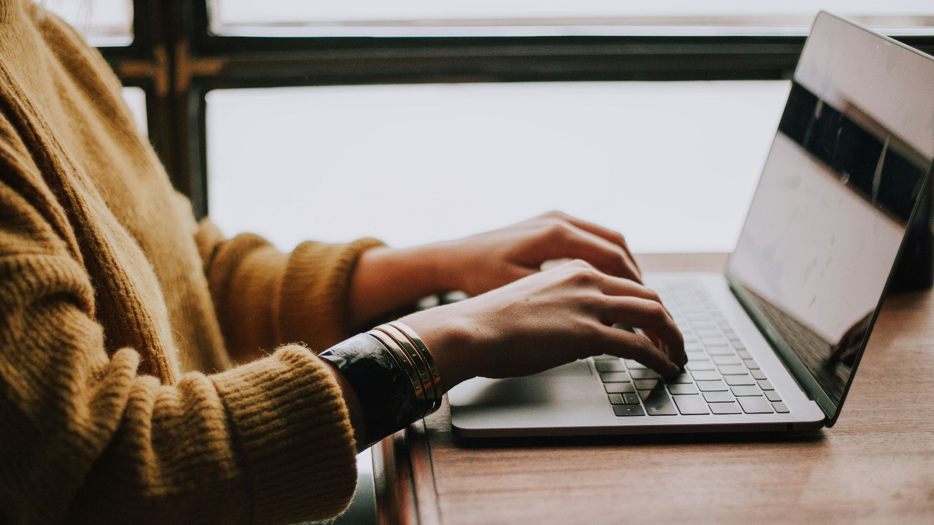 person sitting front of laptop