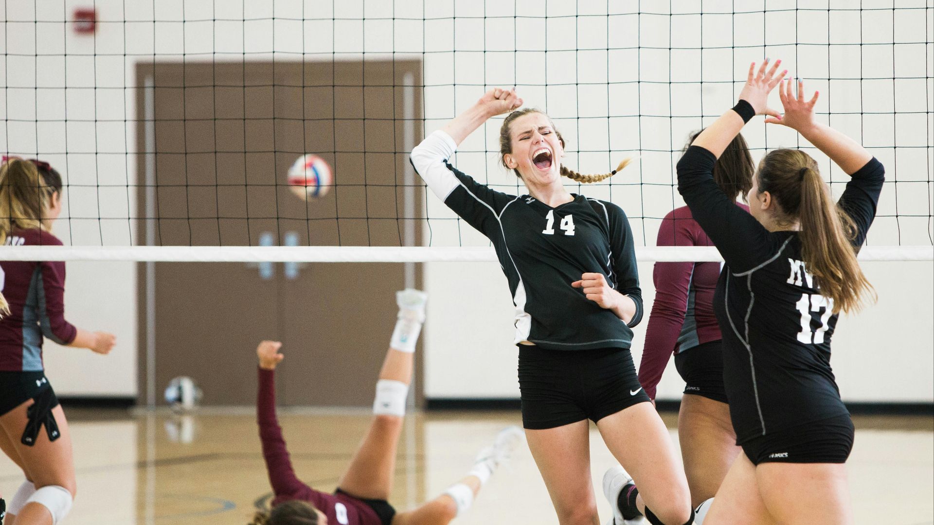 women playing volleyball inside court