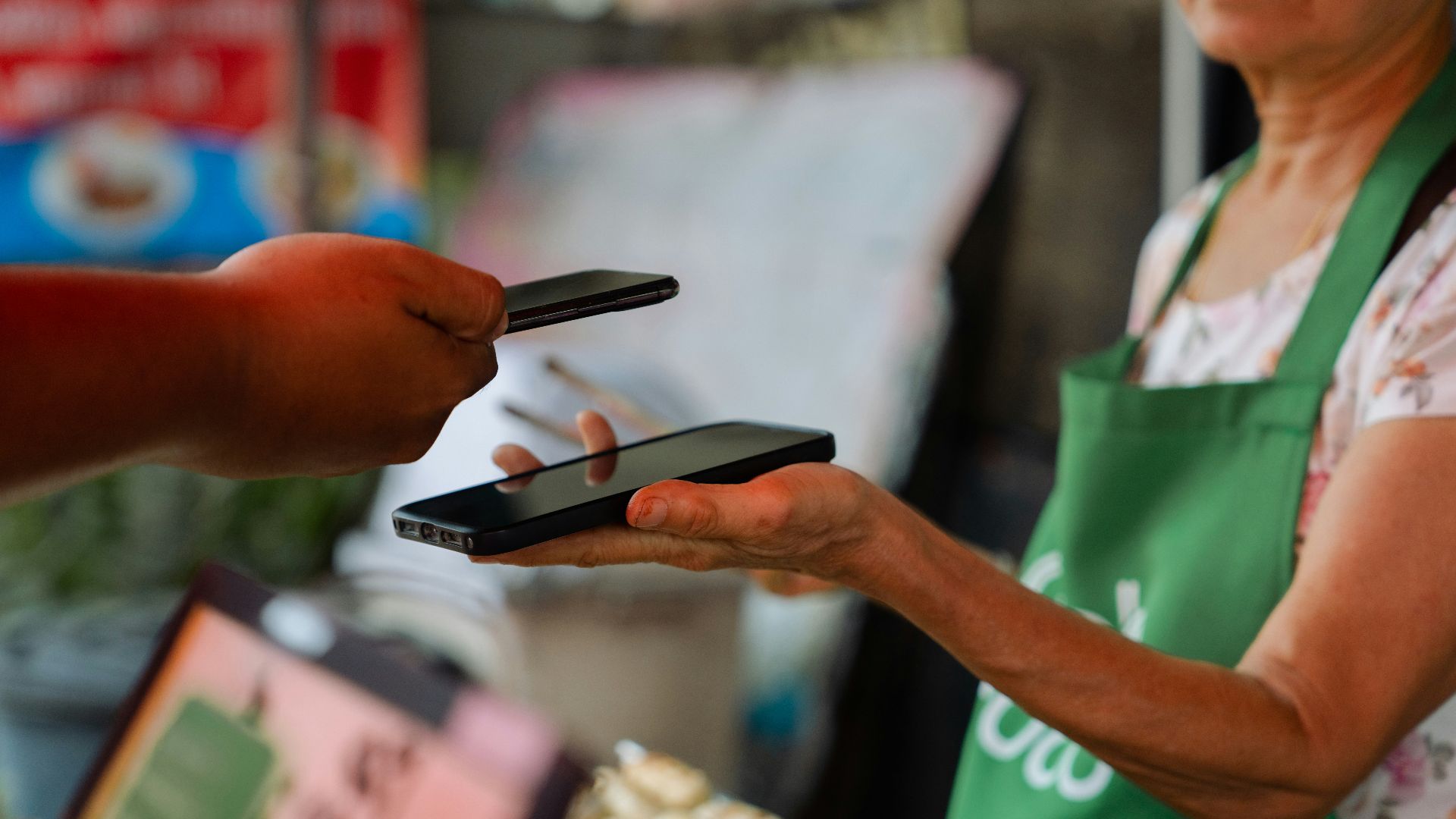 a woman holding two cell phones in her hands