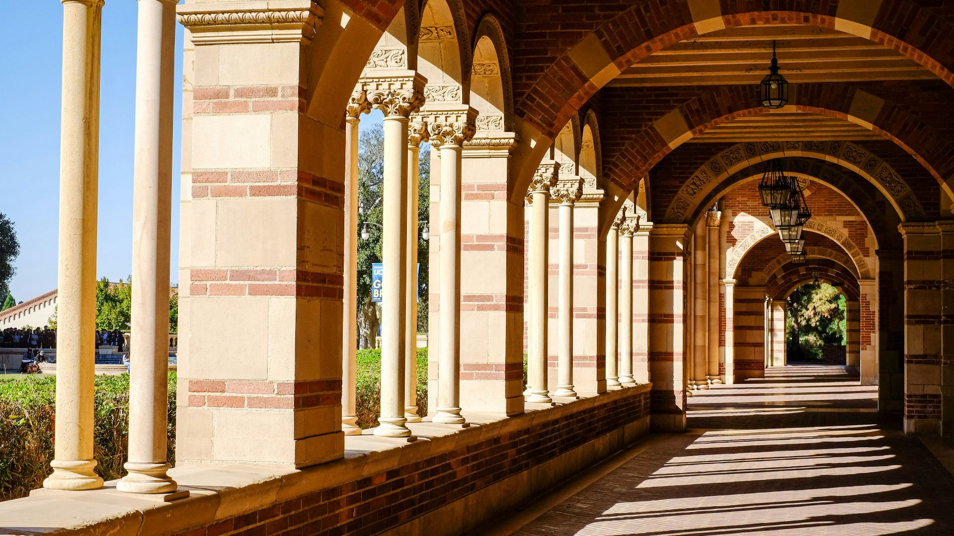 A long hallway with columns and arches on both sides