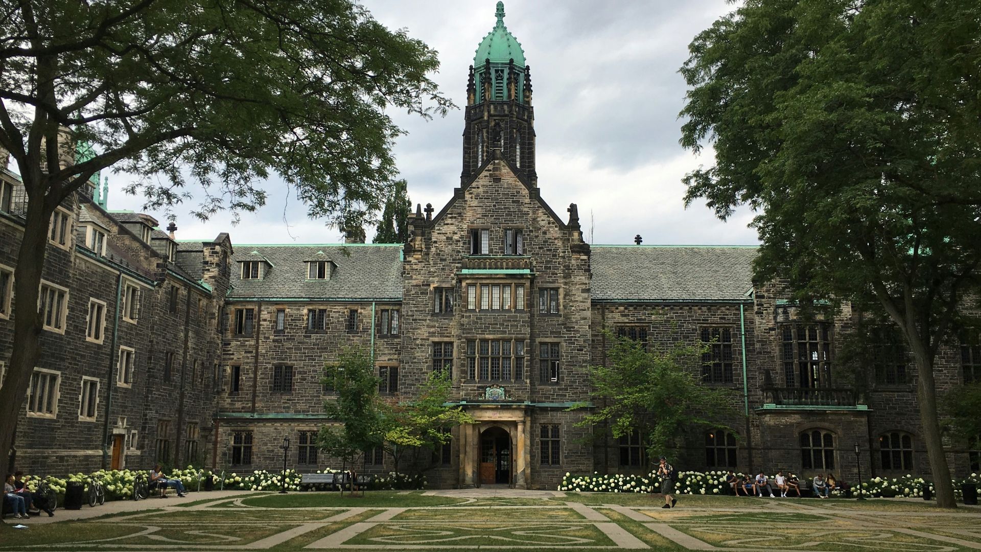 brown and gray concrete building near green trees under blue sky during daytime