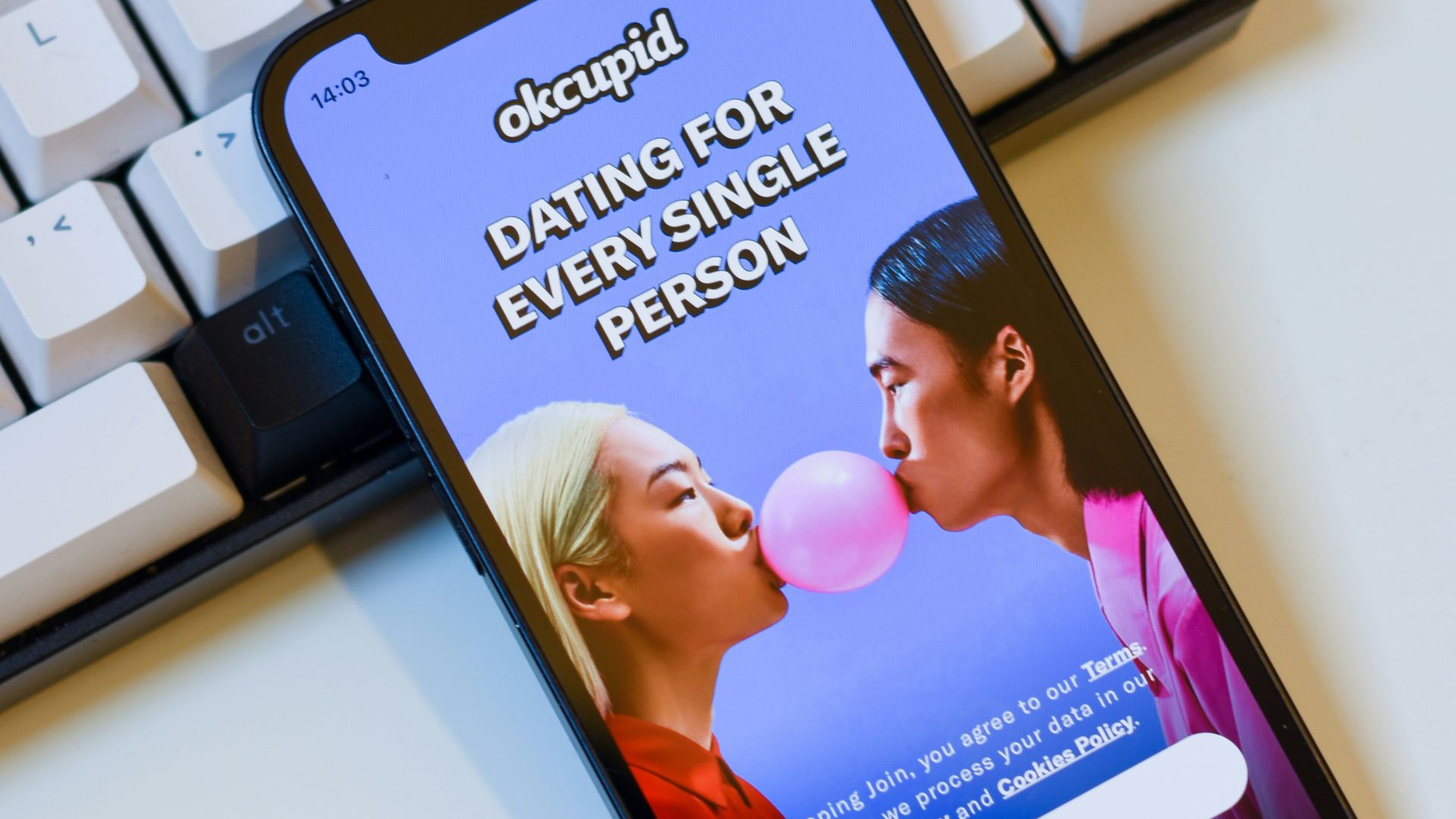 a cell phone sitting next to a keyboard