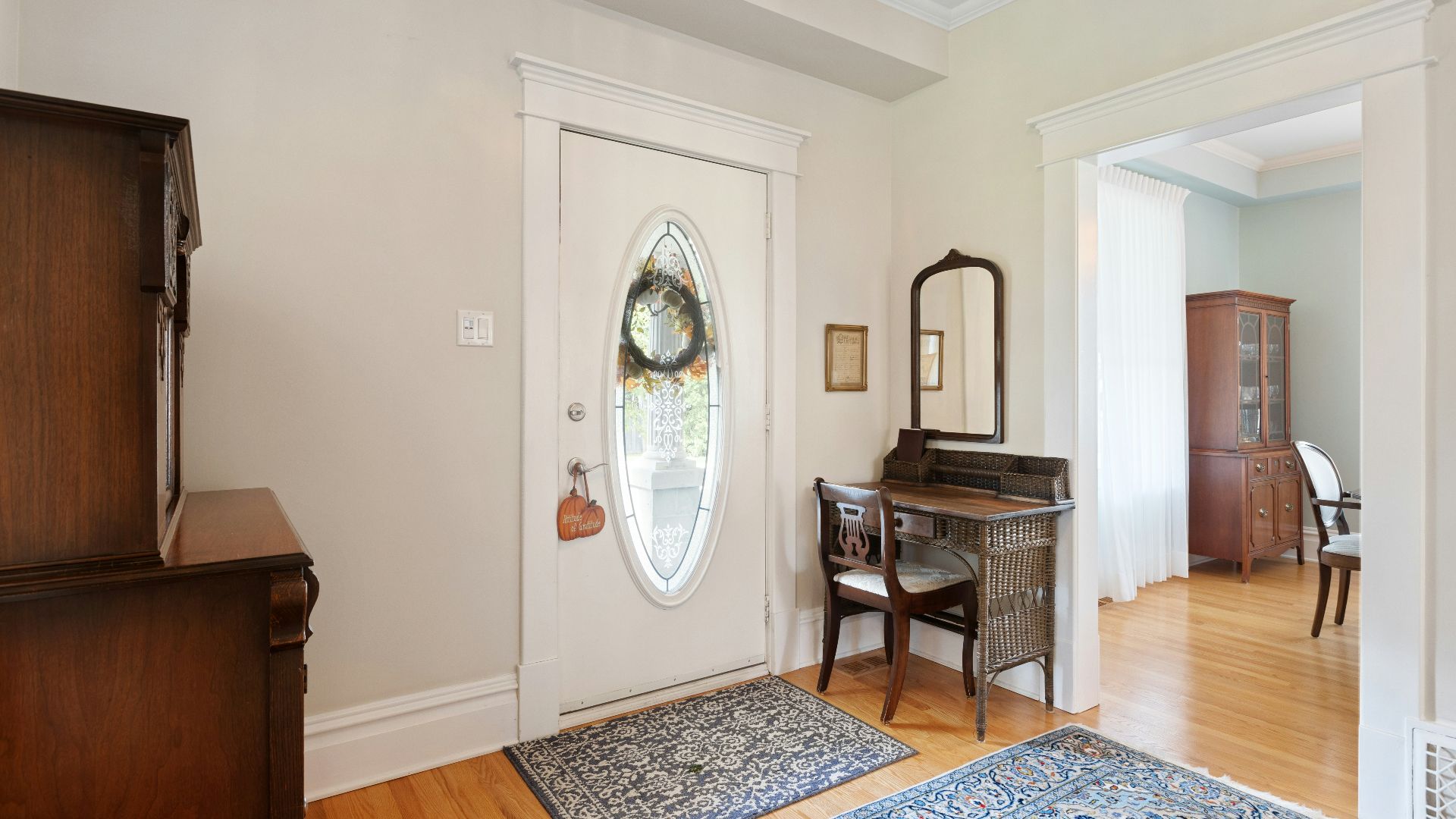 a living room with a piano and a mirror