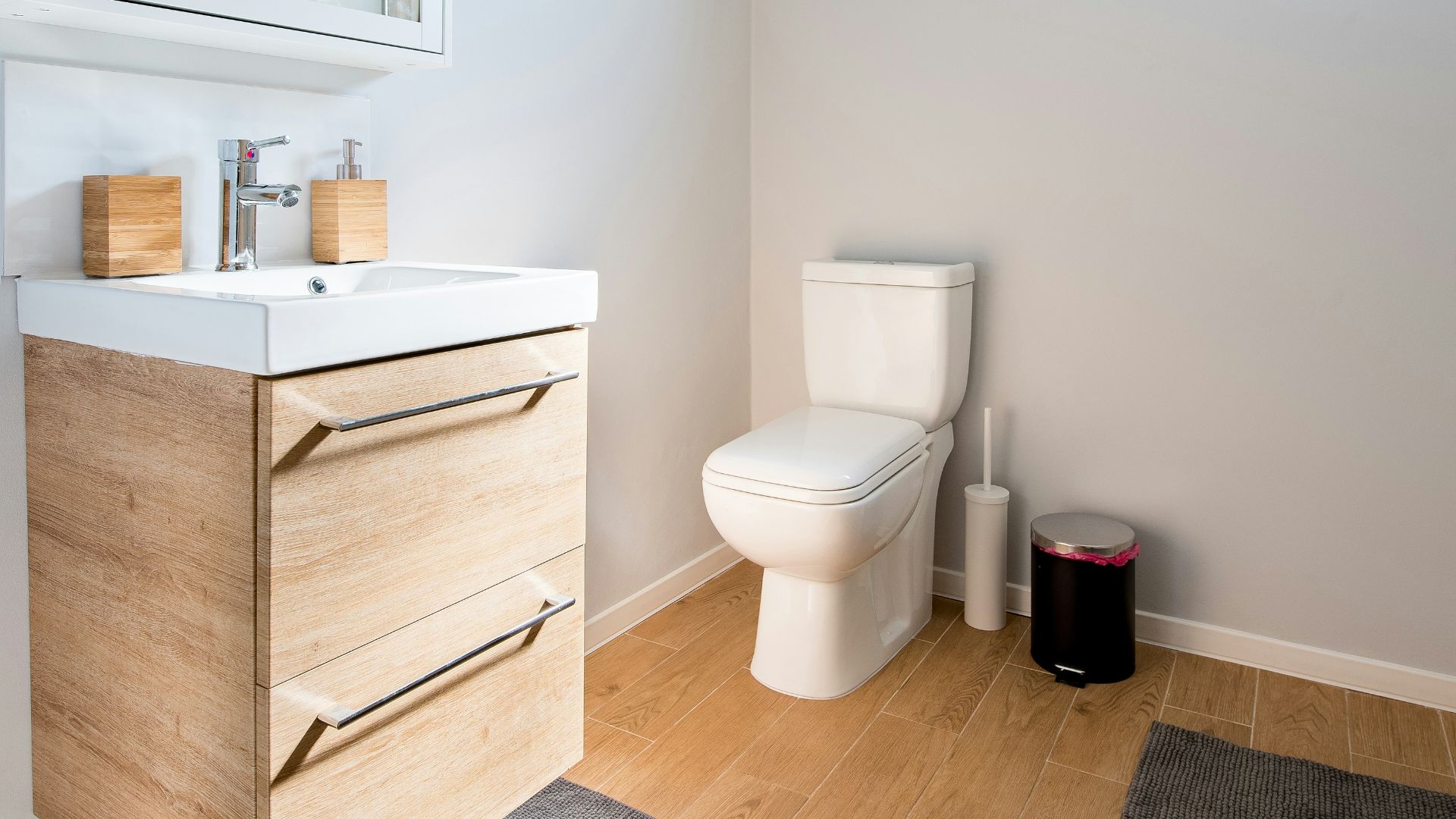white ceramic toilet bowl near vanity combo
