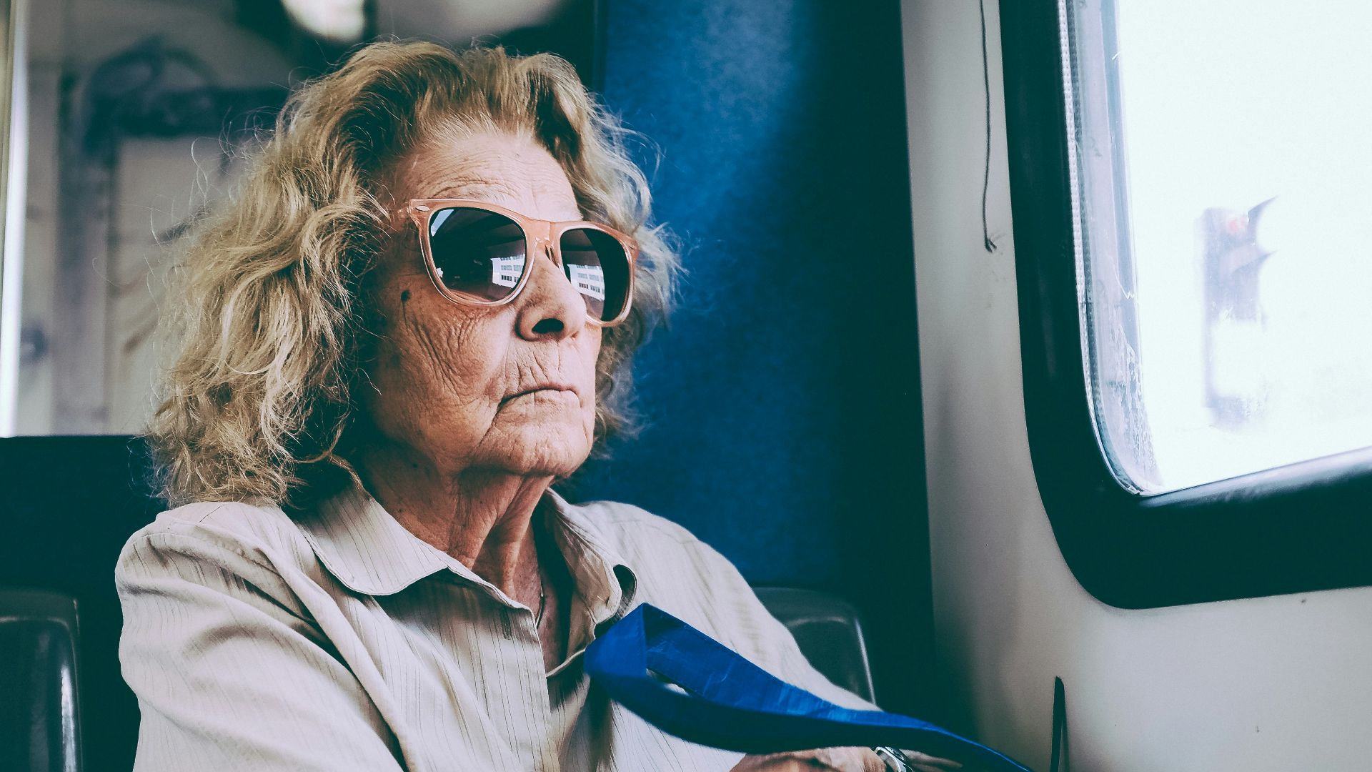 woman sitting on chair in front of window