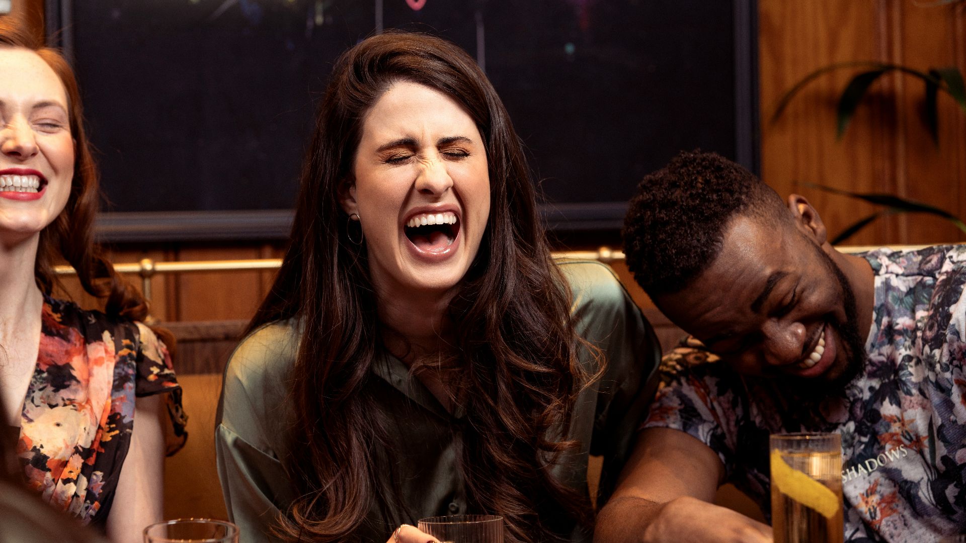 a group of people sitting around a table with drinks
