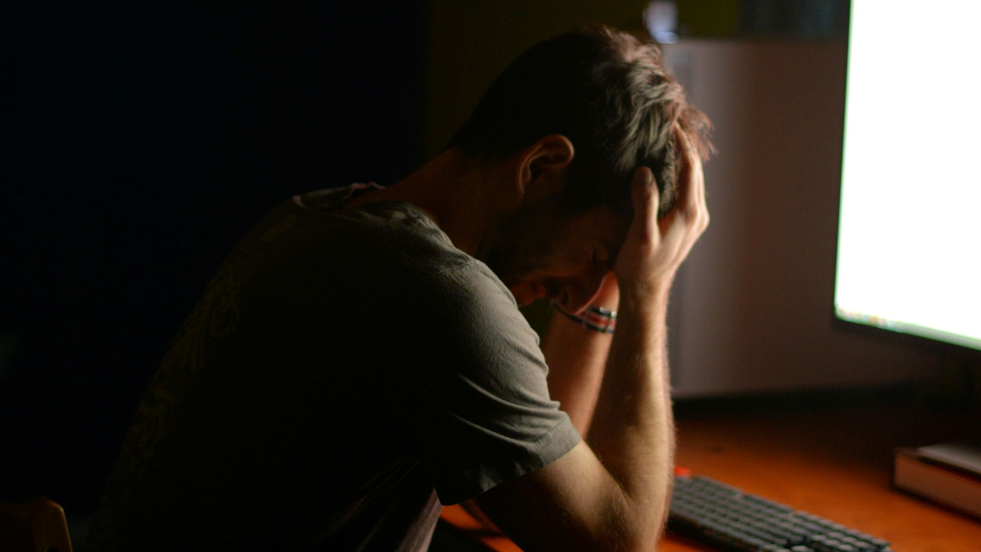 a man sitting at a desk in front of a computer