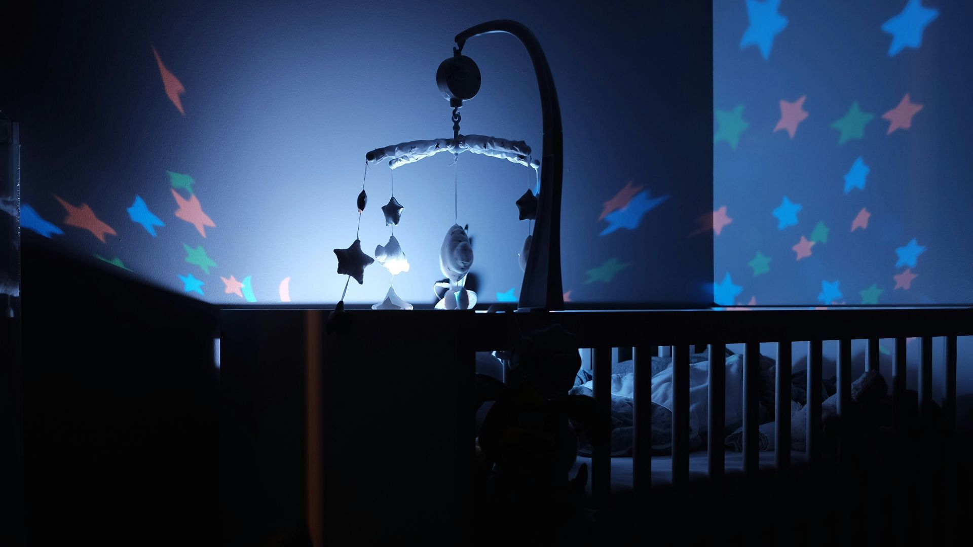 baby's black wooden crib with LED crib mobile