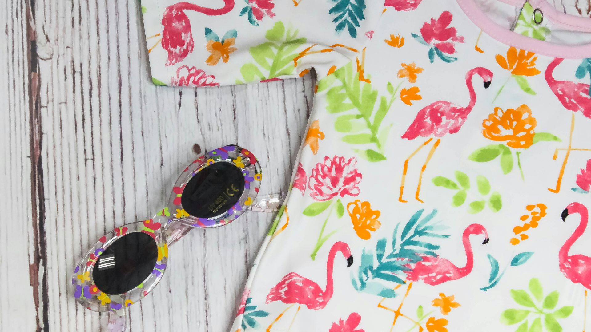 white and multicolored crew-neck shirt near sunglasses