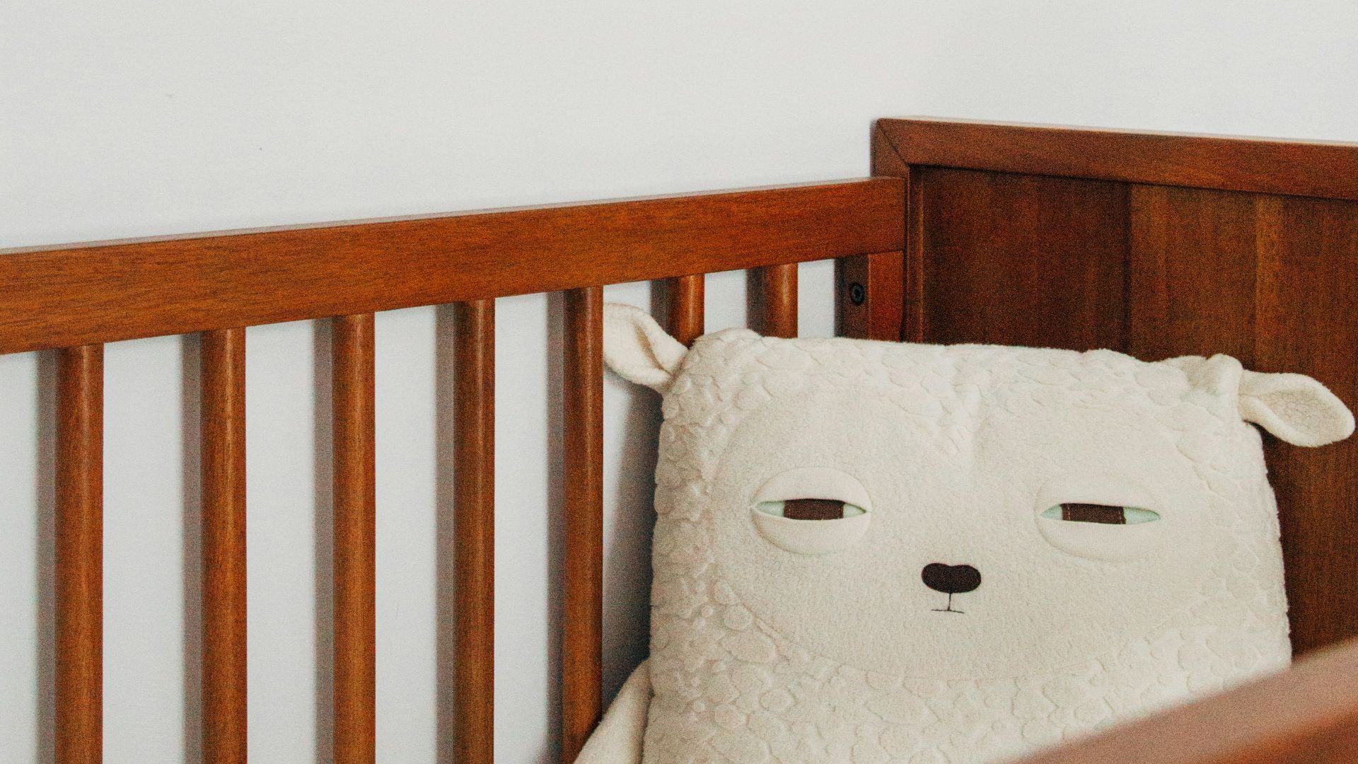 crib with sheep pillow and crib mobile