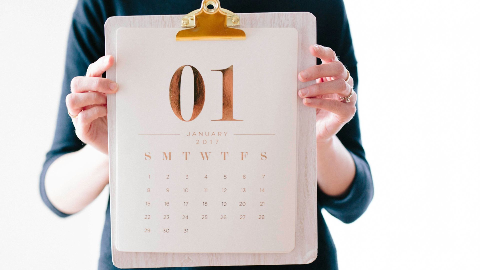 person holding calendar at January