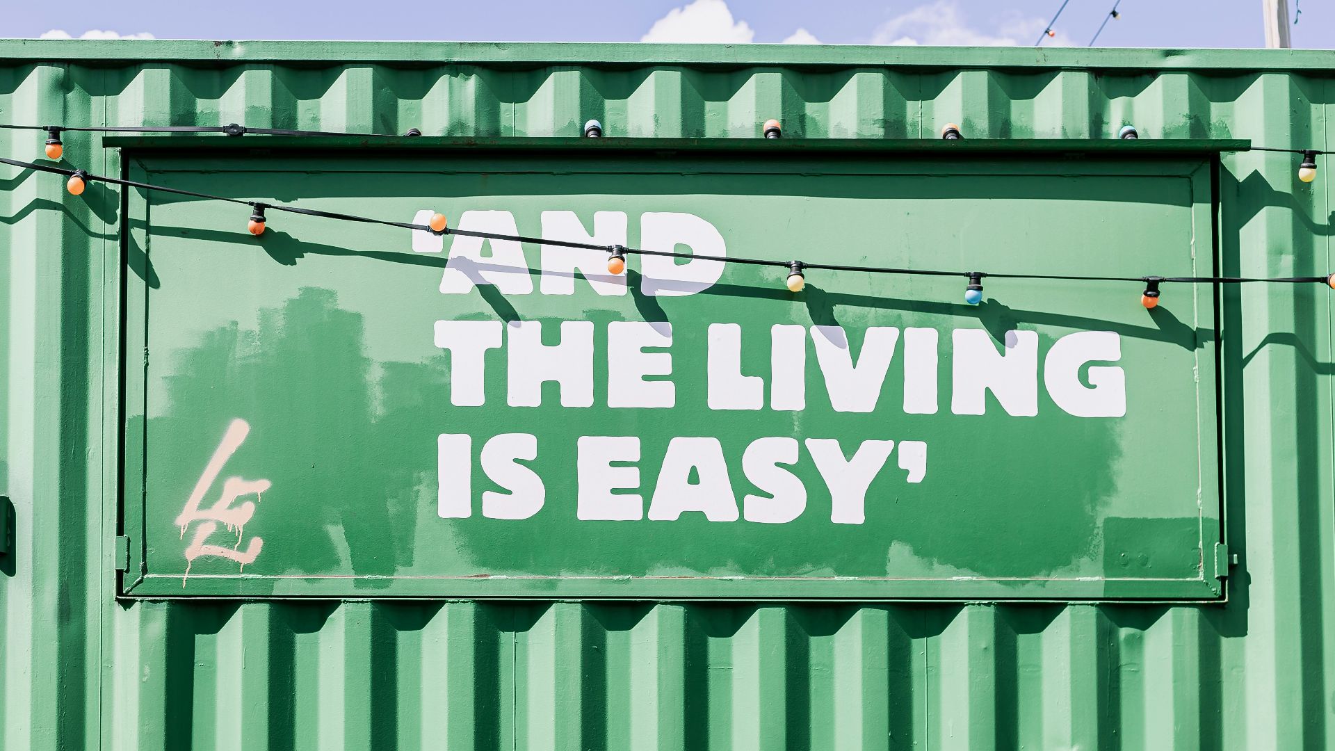 green and white graffiti on wall