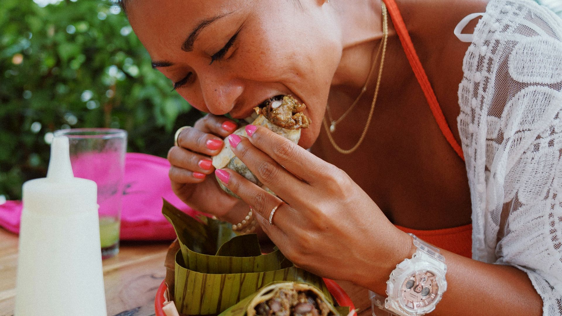 woman in white lace shirt holding brown woven basket