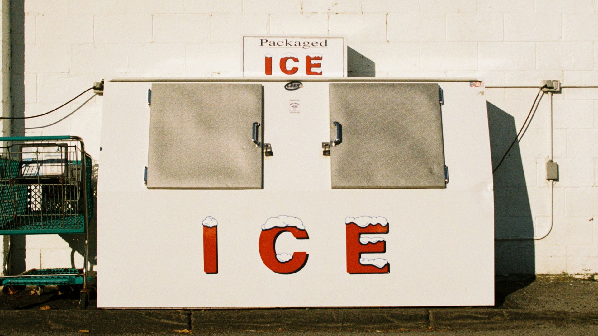 an ice cream stand with a shopping cart in front of it