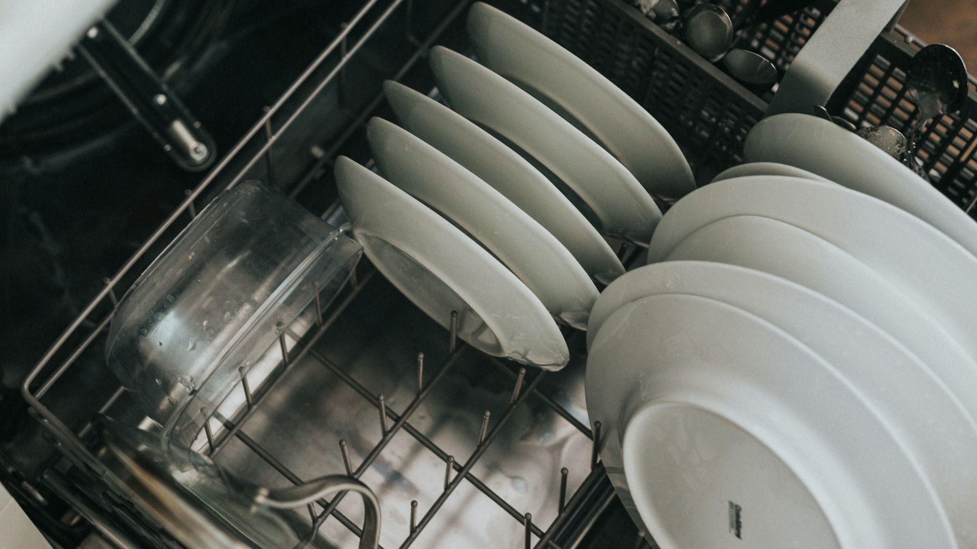 white ceramic plate on black dishwasher
