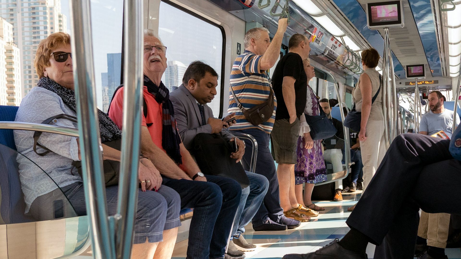 people sitting on blue and white train seat
