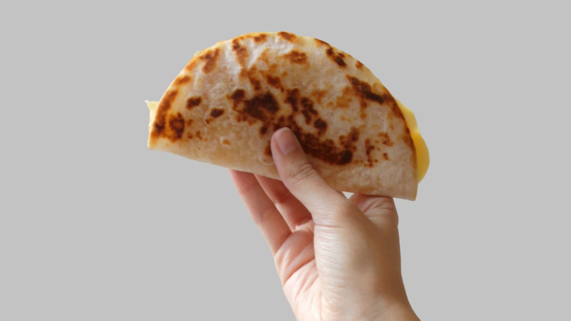 person holding pancake raising it up