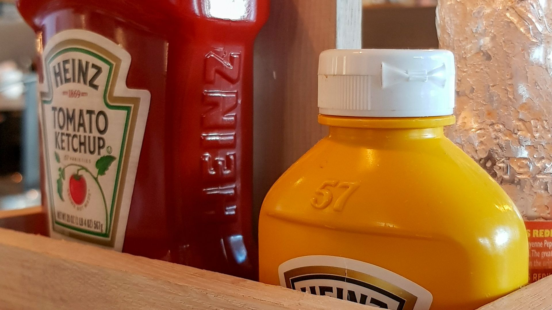 A wooden box filled with juice and condiments