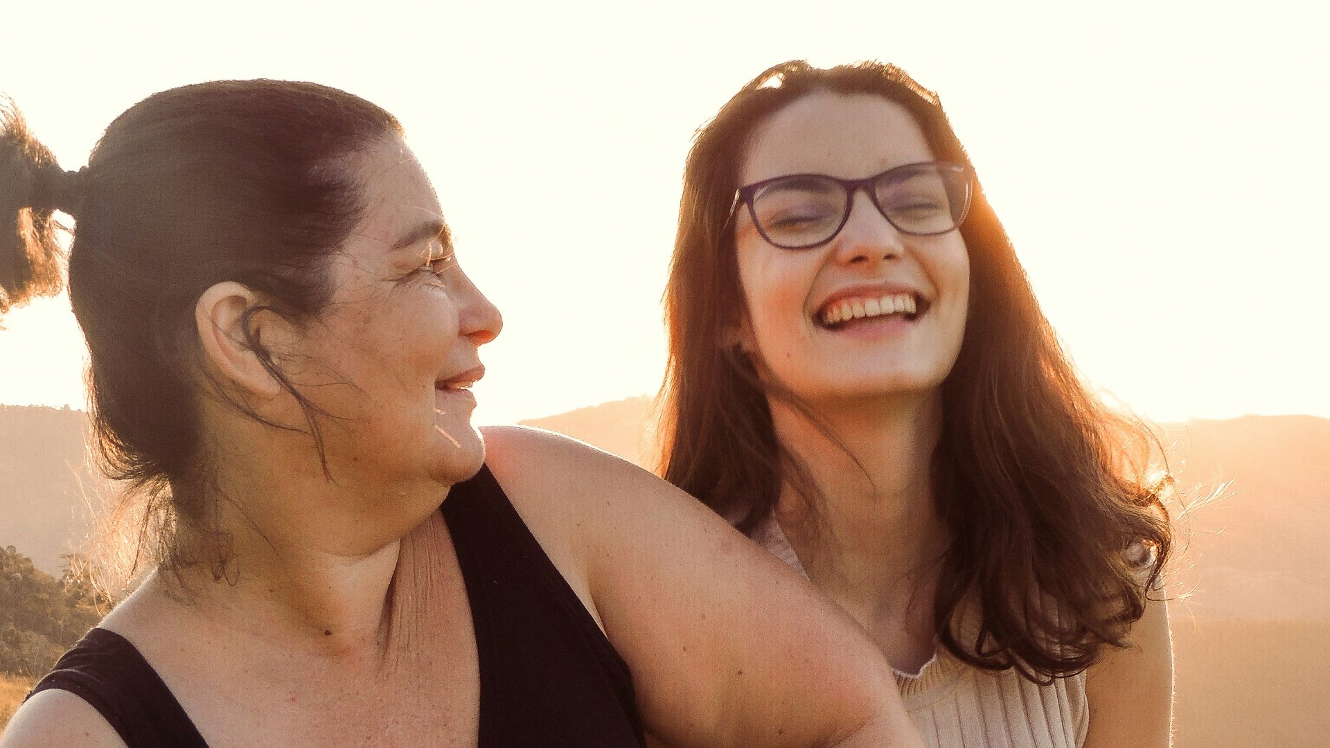 woman in black tank top beside woman in white tank top